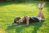 Young woman lying down on grass