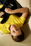 woman playing and training with electric guitar at home