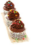 Chocolate cupcakes with colorful decor.