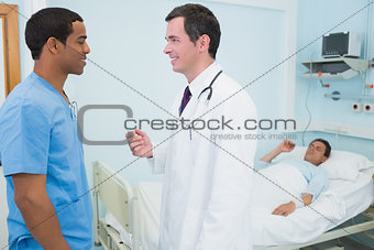 Doctor and a male nurse in a hospital talking