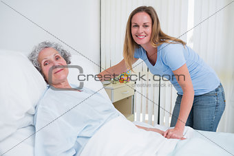Woman holding the hand of a patient in a room