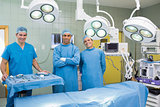 Several Surgeons surrounding an operation table