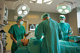Group of surgeons working on a female patient
