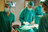 Team of surgeons working on the stomach of a patient