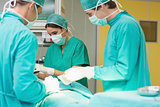 Surgeons working on a patient with his teams