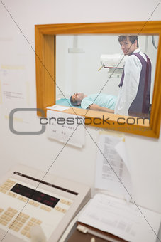 View of doctor doing a radiography through a window