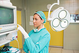 Female surgeon standing next to a monitor