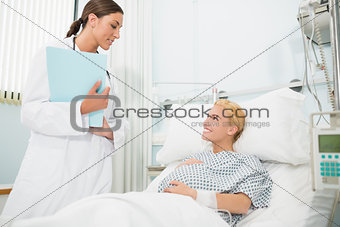 Obstetrician talking to a smiling pregnant patient