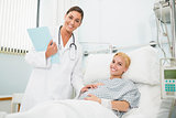 Female obstetrician talking to a smiling pregnant woman