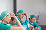 Group of sad surgeons sitting on the floor