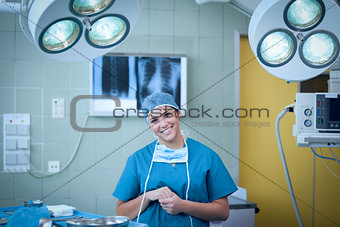 Smiling surgeon under surgical light