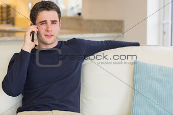 Man sitting on the sofa and calling
