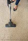 Carpet being hoovered by woman