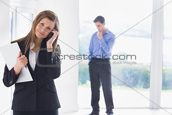 Woman calling on phone while man deciding