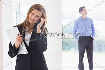 Estate agent on phone while man deciding
