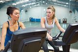 Two women working out on exercise bikes