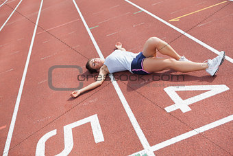Woman taking break on track field