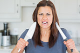 Angry woman holding up knives