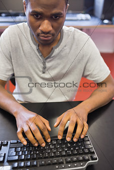 Student typing and looking at computer monitor