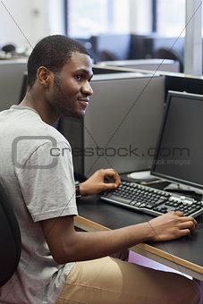 Man sitting at the computer looking up