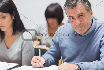Man taking notes in a lecture