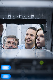 Electricians looking into empty server towers