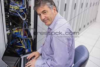 Man doing server maintenance with notebook