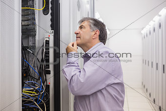 Man looking up thoughtfully into server locker