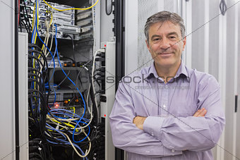 Smiling technician with arms crossed