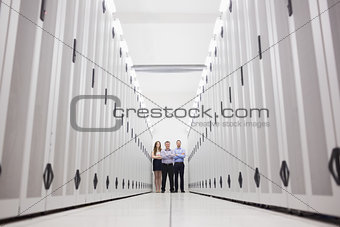Three technicians standing at end of hallway