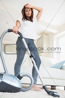 Tired woman doing the hoovering
