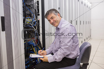 Happy technician repairing the server