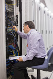 Technician with a clipboard checking servers