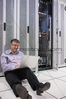 Technician repairing a server on the floor