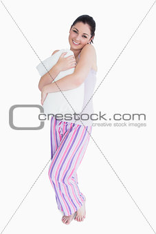 Smiling woman holding a pillow