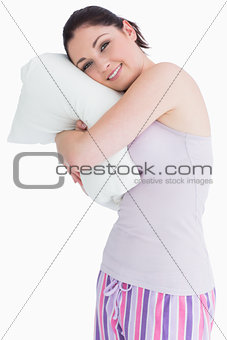 Pretty standing woman relaxing on her comfortable pillow