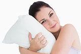 Smiling woman waking up on her pillow