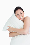 Happy woman hugging a pillow