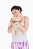 Smiling woman holding a teddy bear