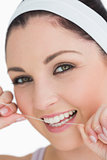 Happy woman using dental floss