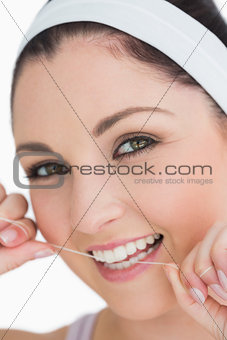 Happy woman using dental floss