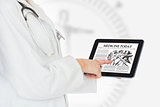 Doctor reading from digital tablet