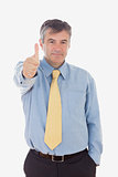 Portrait of businessman showing thumbs up sign
