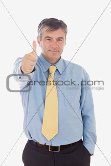 Portrait of businessman showing thumbs up sign