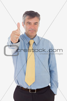 Portrait of businessman gesturing thumbs up