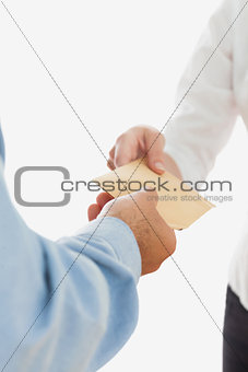 Businessman handing over bribe to coworker