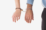 Businesspeople handcuffed together