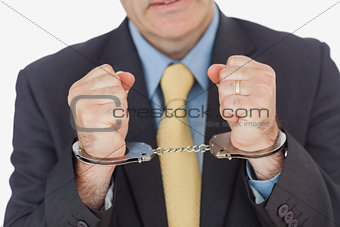 Closeup of businessman with handcuffed hands