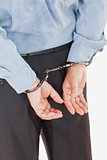 Rear view of businessman in handcuffs