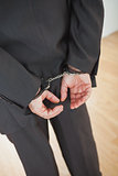Businessman standing with handcuffs